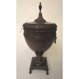 An early 19th century treen caddy in the form of an urn with carved borders on a square base and