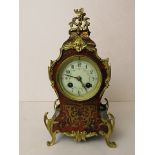 An early 20th century French gilt brass and boulle work mantle clock having an enamelled dial over