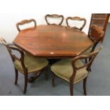 A William IV rosewood octagonal dining table over a carved column and reeded, splayed legs, together