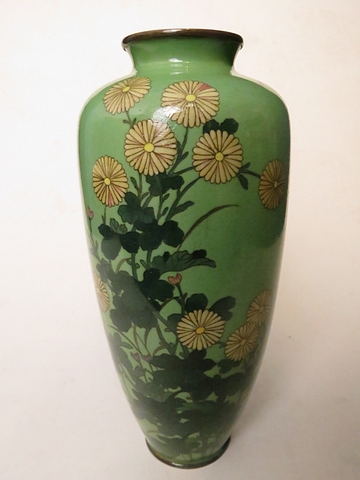 A Japanese cloisonné vase having a pale green ground decorated with flowers, 10" high