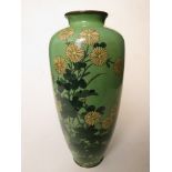 A Japanese cloisonné vase having a pale green ground decorated with flowers, 10" high