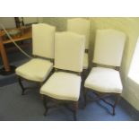 A set of four late 19th century Continental dining chairs having cream upholstery over carved and