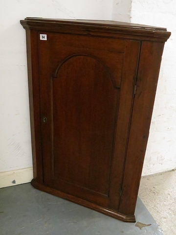 A Georgian mahogany corner cabinet with single arched and fielded door, 34" x 24"