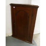 A Georgian mahogany corner cabinet with single arched and fielded door, 34" x 24"