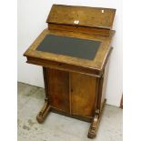 A 19th century walnut Davenport having a fitted raised back over an inlaid desk top and cupboard