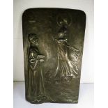 An early 20th century pewter plaque depicting two figures, reverse initialed P R