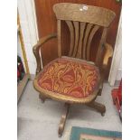 An early 20th century oak swivel office chair