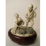 A fine 19th century carved ivory figure group of a fisherman and his family at work, signed to