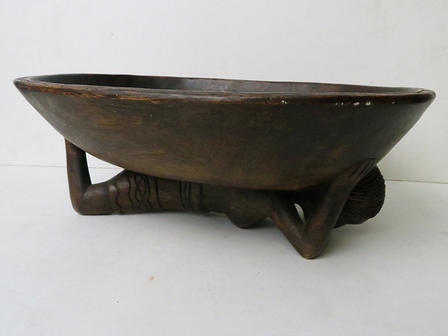 An early to mid 20th century carved treen African bowl supported by a nude female, 13" long
