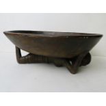 An early to mid 20th century carved treen African bowl supported by a nude female, 13" long