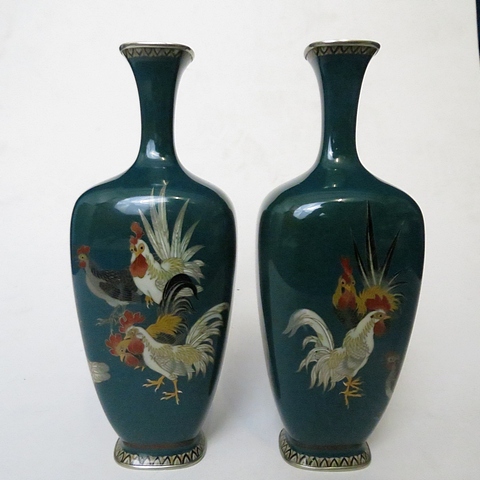 A pair of Japanese cloisonné spill vases having a green enamel base and decorated with cocks and