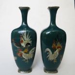 A pair of Japanese cloisonné spill vases having a green enamel base and decorated with cocks and