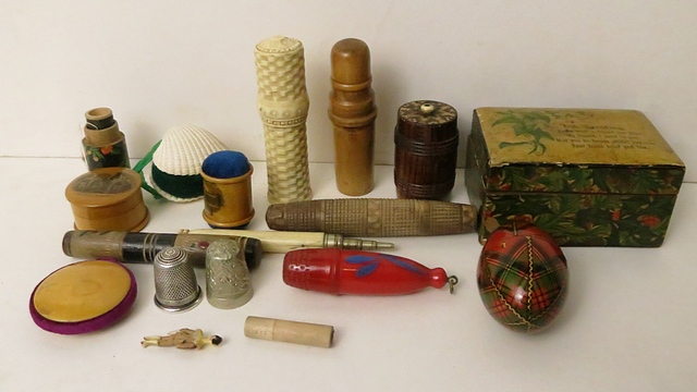 A selection of Tartan ware, Mauchaline ware and carved wooden bodkin cases, tape measures, thimble