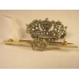 A 14ct gold and platinum bar brooch with a diamond set crown to the centre, together with a silver