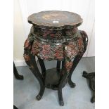 A 19th century oriental lacquered vase stand with painted decoration