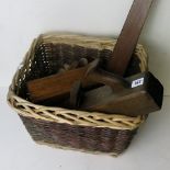 A basket containing a selection of antique wood working tools