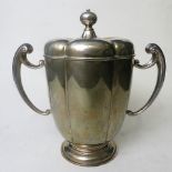 A large Edwardian silver twin handled cup and cover on a raised circular base, London 1912