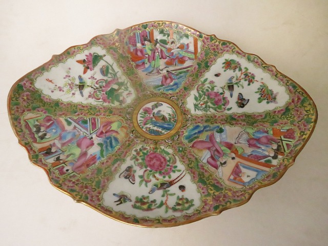 A 19th century Canton footed dish of shaped oval form, decorated with reserves and central medallion