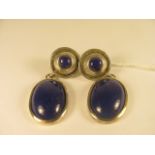 A pair of vintage white metal earrings set with large lapis lazuli cabochons