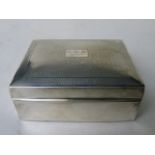 A 1920s silver cigarette box having an engine turned lid