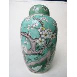 A late 19th/early 20th century Chinese porcelain ovoid vase and cover decorated with a bird