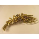 An 18ct yellow gold brooch forming wheat set with ruby and diamond clusters