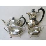 An early 20th century silver four piece tea service comprising teapot, milk, sugar and hot water