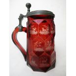 Bohemian ruby flashed, cut and engraved stein, the body hexagonally faceted, each facet engraved