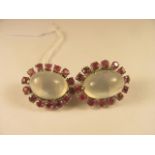 A pair of matching moonstone and ruby ear clips