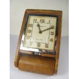 A 1920s Goldsmiths and Silversmiths leather cased travel clock