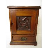 A Victorian mahogany stationary box with carved front door, revealing a pigeonhole interior and