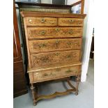 A Queen Ann chest of two short and four long drawers on later stand