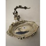 An early 20th century silver grape dish with a single hanging handle decorated with grape vines on
