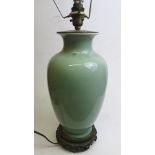 Circa 1910 a Chinese Caledon glazed vase converted to a table  lamp with brass fittings and carved
