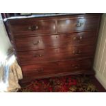 A Georgian mahogany chest of two short and three long graduated drawers, flanked by blind fretwork