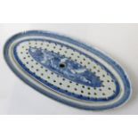 An 18th century Chinese blue and white porcelain salmon dish of oval form, with matching liner