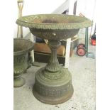 A large 19th century ornate embossed, cast metal urn on a column support and plinth base, 44 high