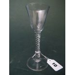 An 18th century English air twist drinking glass, round funnel bowl on a plain air twist stem and