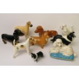 A collection of Beswick pottery dog figures to include a large and small black and white rough