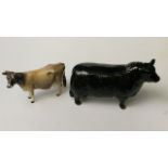 A Beswick pottery model of an Aberdeen Angus bull, model no 1562 and a Jersey cow model no 1345