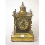 A Victorian brass cased mantle clock with keys and pendulum having brass turned columns over a