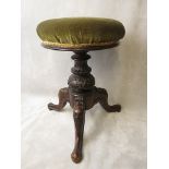 A Victorian mahogany piano stool with upholstered swivel top and carved decoration