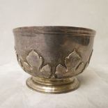 An early 20th century silver bowl with raised decoration on a circular base, London 1920, 4
