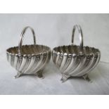 A pair of Victorian silver salts having gadrooned bowls on raised feet, by Hilliard and