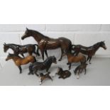 A collection of brown glazed Beswick horses, comprising one X large, two large, three smaller and