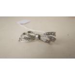 A vintage diamond set bow brooch set with old brilliant cut and baguette cut diamonds, in white