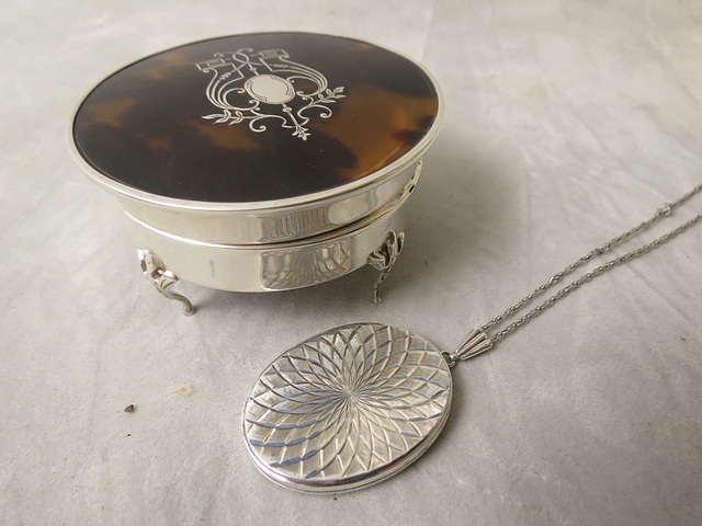 An Edwardian silver and tortoiseshell inlaid jewellery casket with a silver George Jensen locket,