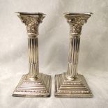 A pair of 20th century silver Corinthian column candlesticks on stepped square bases, London 1962, 8