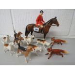 A Beswick fox hunting set comprising huntsman on horseback, two foxes and eight hounds