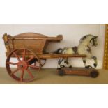 An antique carved treen child's pull along horse and cart with painted decoration, horse 18 long,